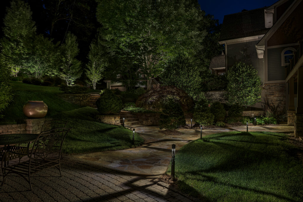 Backyard beautifully lit with landscape lighting.